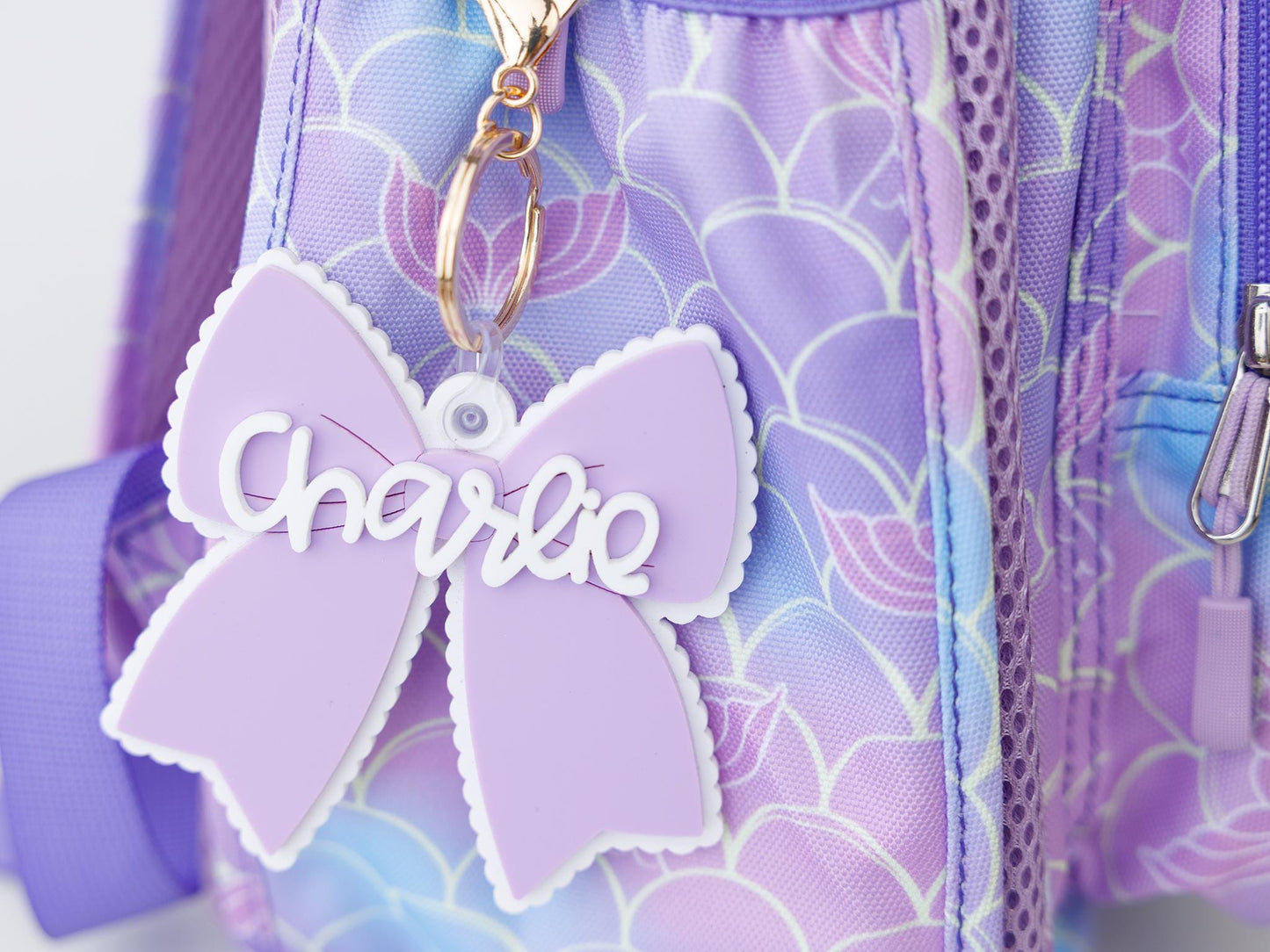Scallop bow backpack name tag