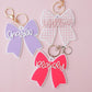 Scallop bow backpack name tag