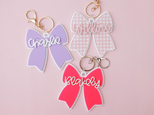 Scallop bow backpack name tag