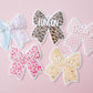 Scallop bow backpack name tag
