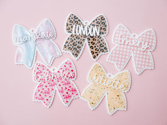 Scallop bow backpack name tag